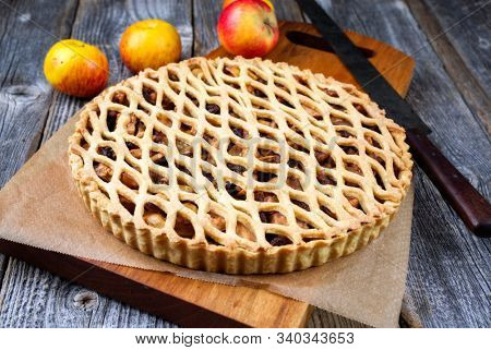 Traditional apple jalousie cake offered as closeup on a modern design wooden board 