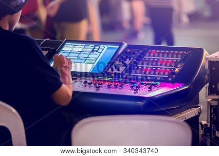 Technicians Are Controlling The Sound System And Lighting System On The Concert Stage.