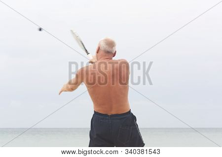 Adult Male Playing Matkot On The Beach