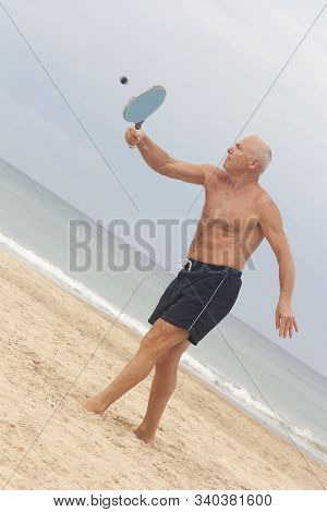 Adult Male Playing Matkot On The Beach