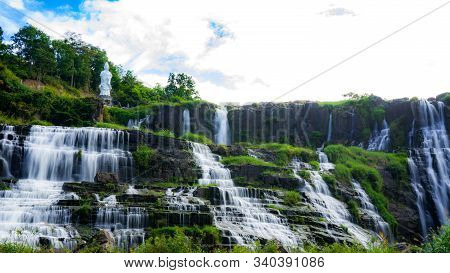 Amazing Pongour waterfall in Vietnam, Da Lat with the Buddha on the top.Travel concept ,wonderful vi
