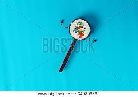 Ethnic Drum Damaru With Pattern. Isolated, On Blue Background, Copy Space, Horizontal Arrangement, T