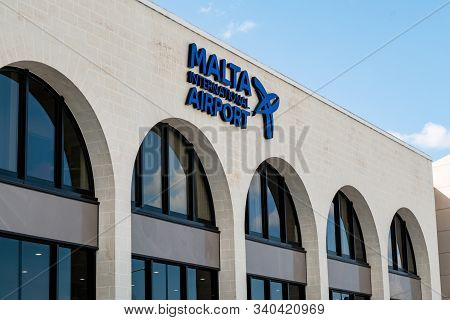 Luqa, Malta - October 26, 2019: The White Building Of The Malta International Airport With Arch Wind