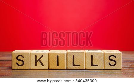 Wooden Blocks With The Word Skills. Knowledge And Skill. Self Improvement. Education Concept. Traini