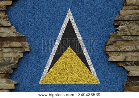 Saint Lucia Flag Depicted In Paint Colors On Old Stone Wall Closeup. Textured Banner On Rock Wall Ba