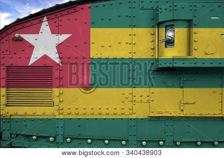 Togo Flag Depicted On Side Part Of Military Armored Tank Closeup. Army Forces Conceptual Background