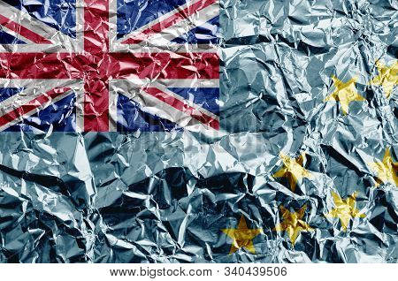 Tuvalu Flag Depicted In Paint Colors On Shiny Crumpled Aluminium Foil Closeup. Textured Banner On Ro