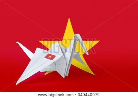 Vietnam Flag Depicted On Paper Origami Crane Wing. Handmade Arts Concept