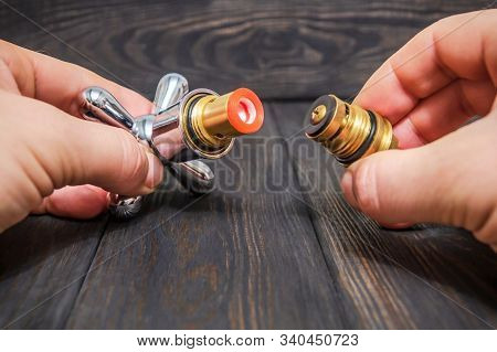 Cruciform Hot And Cold Water Main Switch Of Spare Parts Holding In His Hands Master Plumber Before R
