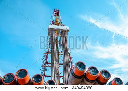 Oil And Gas Drilling Rig Onshore Dessert With Dramatic Cloudscape. Oil Drilling Rig Operation On The