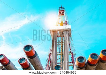Oil And Gas Drilling Rig Onshore Dessert With Dramatic Cloudscape. Oil Drilling Rig Operation On The