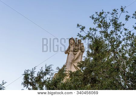 Jerusalem, Israel, December 07, 2019 : Statue Of The Mother Of God With A Baby In Her Arms On The Ro