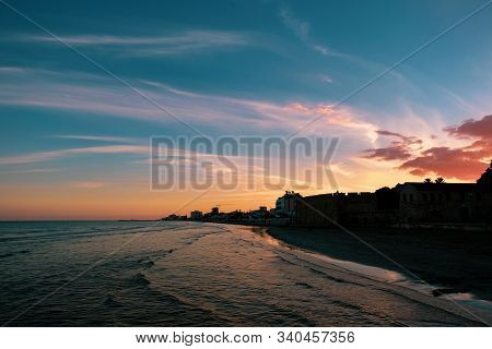 Sunset Over The City Of Larnaca Viewed From The Sea