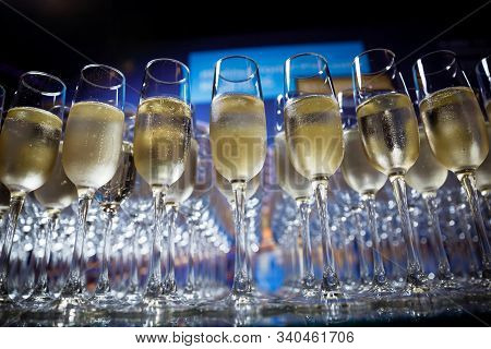 Many Champagne Glasses Stand On A Glass Table