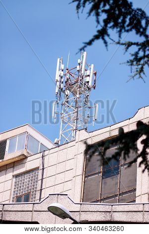Telecommunication Base Stations Network Repeaters On The Roof Of Building. The Cellular Communicatio