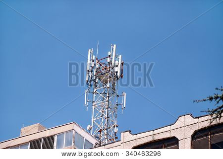 Telecommunication Base Stations Network Repeaters On The Roof Of Building. The Cellular Communicatio