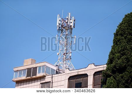 Telecommunication Base Stations Network Repeaters On The Roof Of Building. The Cellular Communicatio