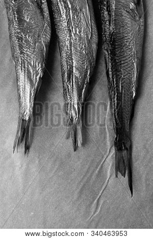Three Smoked Sea Fish On Parchment Paper. Caught And Cooked Herring. Black And White Minimalistic St