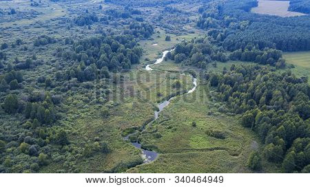 Aerial View Of A Green Fores And River. Texture And Beatiful Background.