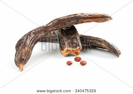 Carob Carob Fruit And Seeds On White Background. Isolate. Organic Carob Beans, A Healthy Alternative