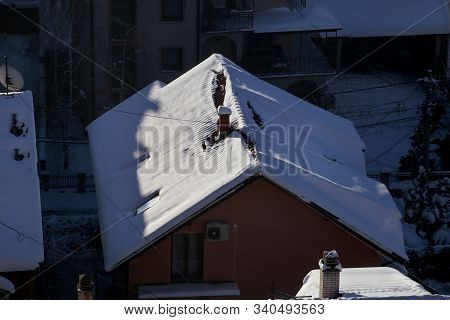 Beautiful Winter View Of Houses And Buildings With Roofs Covered With Heavy Snow. In Snowy Season, R