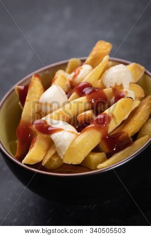 Canadian poutine, fried potato chips with cheese and gravy or sauce