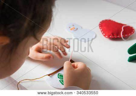 The Hand Of The Child Make Snowman For Christmas Greeting Card. Xmas Toys Decoration For Greeting Ca