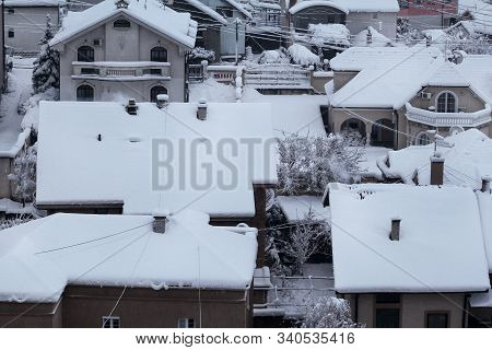 Beautiful Winter View Of Houses And Buildings With Roofs Covered With Heavy Snow. In Snowy Season, R