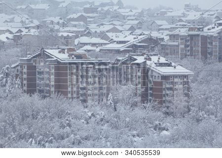 Beautiful Winter View Of Houses And Buildings With Roofs Covered With Heavy Snow. In Snowy Season, R