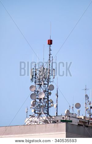 Telecommunication Base Stations Network Repeaters On The Roof Of Building. The Cellular Communicatio