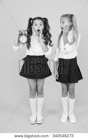 School Time. Schoolgirls And Alarm Clock. Children School Pupils. Knowledge Day. Surprised Shocked K