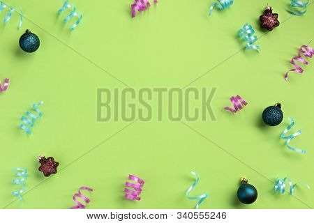 Christmas, New Year, Winter Concept. Colorful Serpentine And Balls, On Green  Background. Flat Lay, 