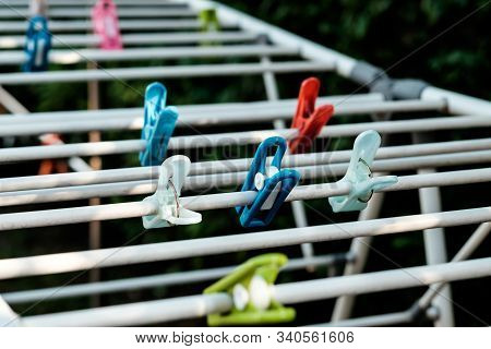 Cloth Pegs In Multicolor Attached To The Clothlines