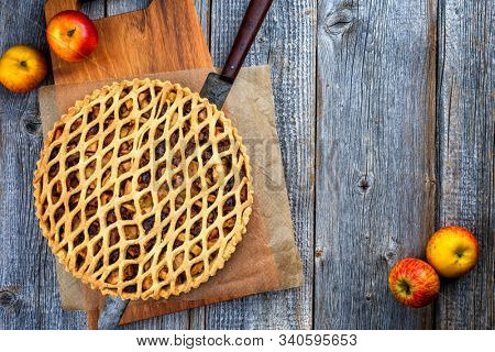 Traditional apple jalousie cake offered as top view on a modern design wooden board with copy space 