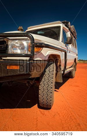 Western Australia â Outback track with 4WD car on red sand at the ocean at Dampier Peninsula
