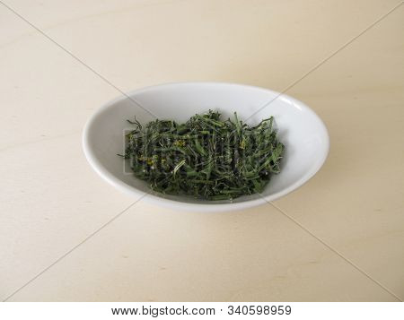 Dried Hedge Mustard On A Wooden Board