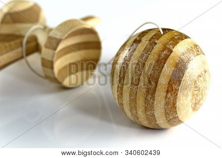 Kendama Japanese Wooden Toy On Isolated On White. Used Kendama With Scratches And Dents On The Ball.
