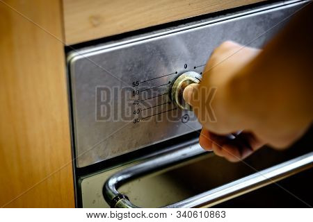 Hand Turning An Oven On