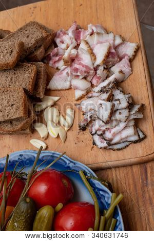 Bacon, Bread And Cucumber Over Wooden Background. Russian And Ukrainian Traditional Appetizer, Black