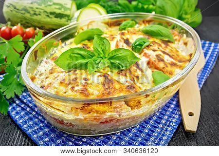 Zucchini Baked With Tomatoes In Pan On Dark Board