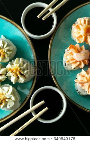 Sushi Rolls In Blue Plate, Chopsticks And Soy Sauce