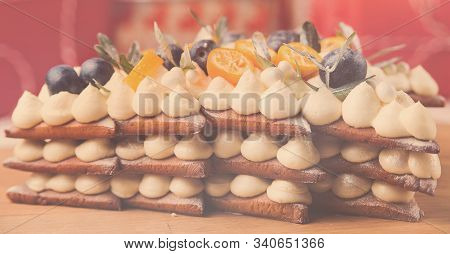 Homemade Christmas Layer Cake With Cheesecream And Festive Fruit Decorations, Close Up