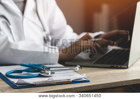 Medicine Doctor Hand Explaining For Patient At Consulting Room, Working On Laptop Computer On Desk I