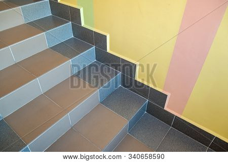 Wide Staicase Covered With Ceramic Tiles Indoors In A House Interior.