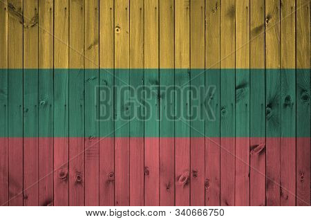 Lithuania Flag Depicted In Bright Paint Colors On Old Wooden Wall. Textured Banner On Rough Backgrou
