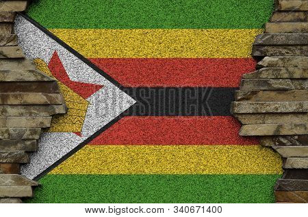 Zimbabwe Flag Depicted In Paint Colors On Old Stone Wall Closeup. Textured Banner On Rock Wall Backg