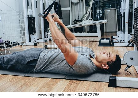 Kinesitherapy, A Mixed Race Man Is Training In A Wellness Center, On Special Simulators