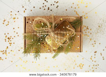Christmas Present. Craft Paper Box Decorated With Evergreen Tree, Golden Card And Cord.