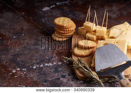 Pieces Of Cheese, Nuts, Raisins, Snacks For Wine On A Wooden Background. Appetitive