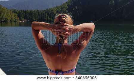 Woman Sit On A Sunbed In Sunglasses And Swimming Suit. Girl Rest On A Flood Wood Underwater Pier. Th